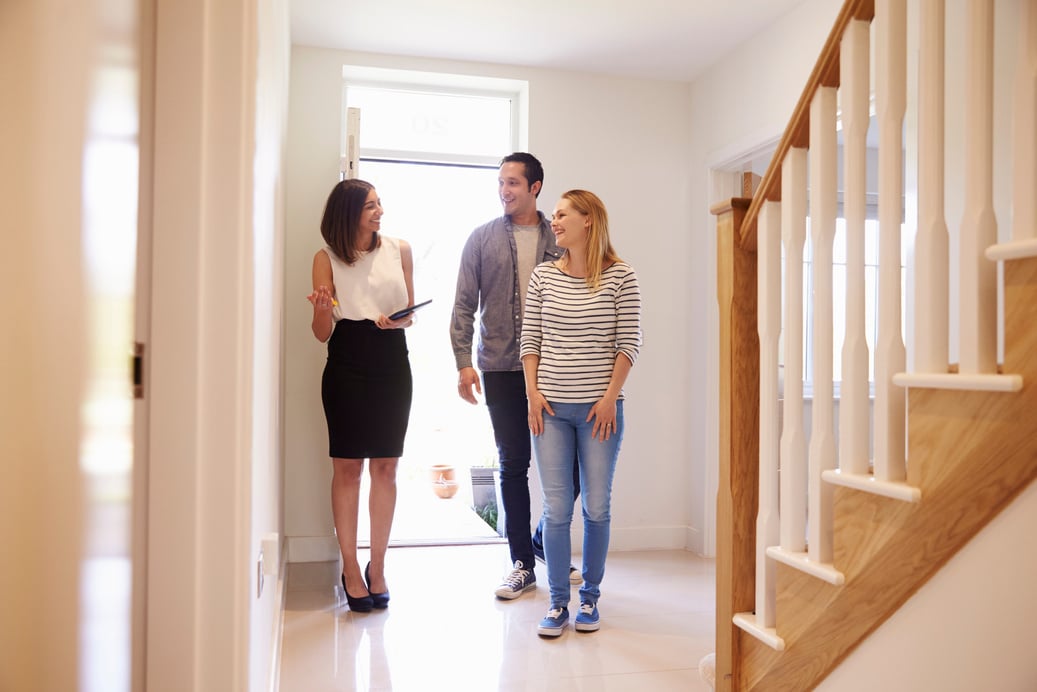 Realtor Showing Young Couple around Property for Sale